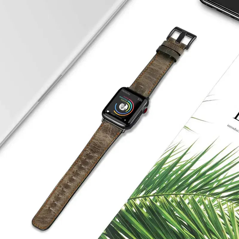 Distressed leather Apple Watch band flat-lay detail