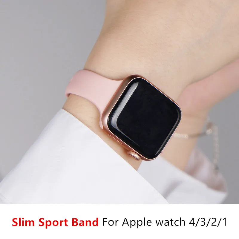 Pink tapered silicone Apple Watch band worn on wrist