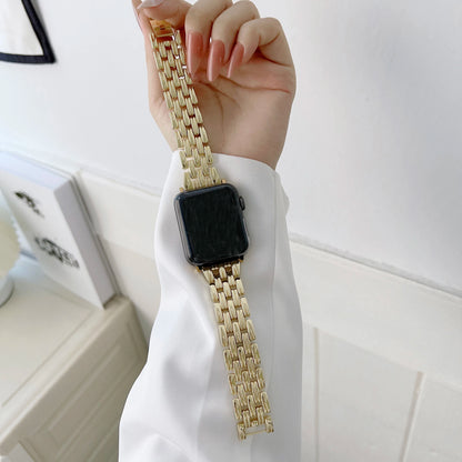 Stylish Apple Watch with a luxurious gold stainless steel band in hand, showcasing modern sophistication and elegance.