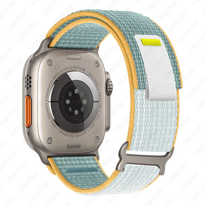 Apple Watch with Trail Loop Nylon Strap in blue and yellow, featuring durable and breathable design for comfort.