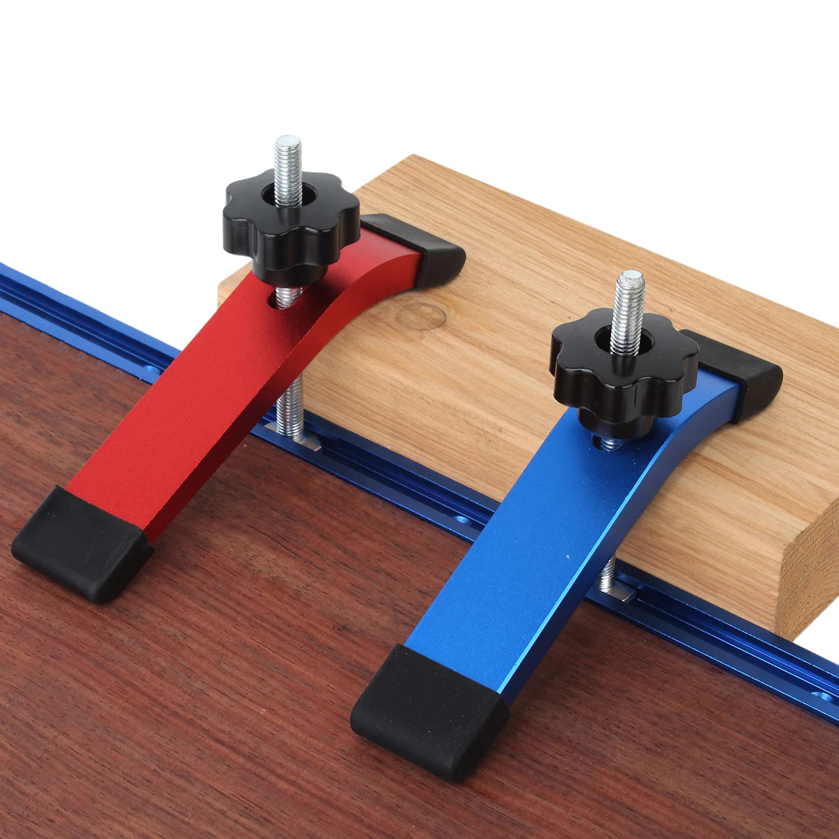 T-track hold-down clamps holding a board on a T-track