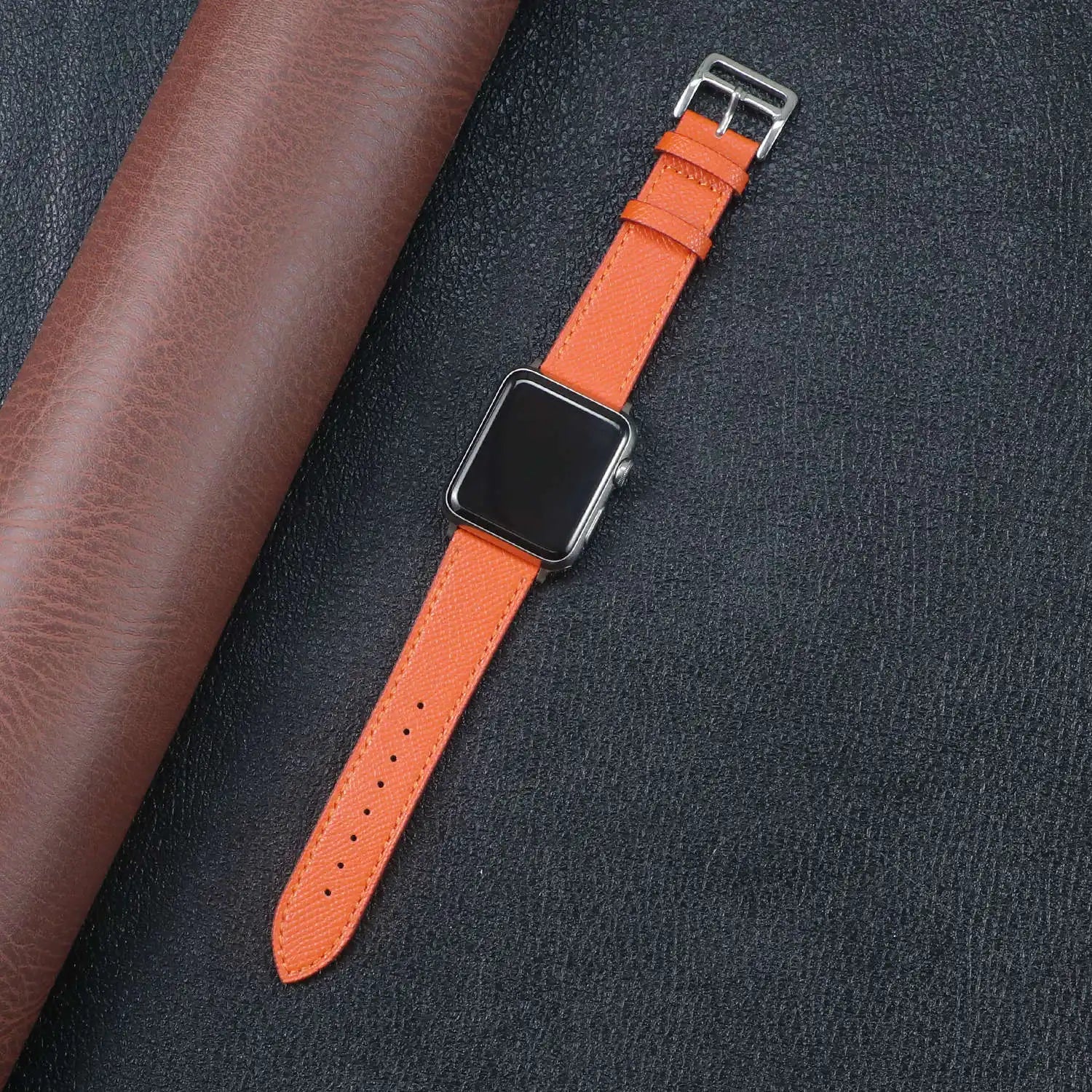Orange Apple Watch Fabric Band on a black background, showcasing durability and style with a metal buckle clasp.