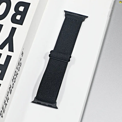 Apple Watch nylon sport loop strap displayed in packaging, featuring a breathable black design for comfort and style.