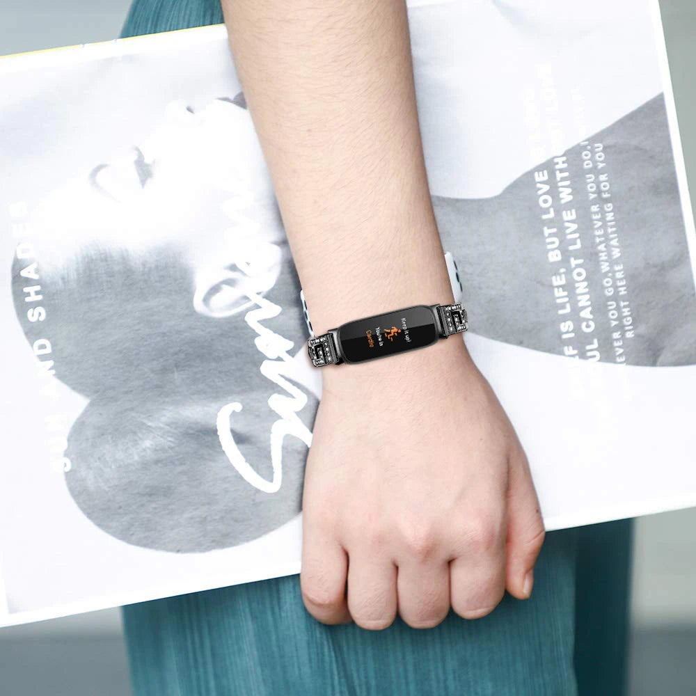 Fitbit Inspire 3 with elegant metal diamond band worn on wrist, showcasing stylish smartwatch accessory and fashionable look.