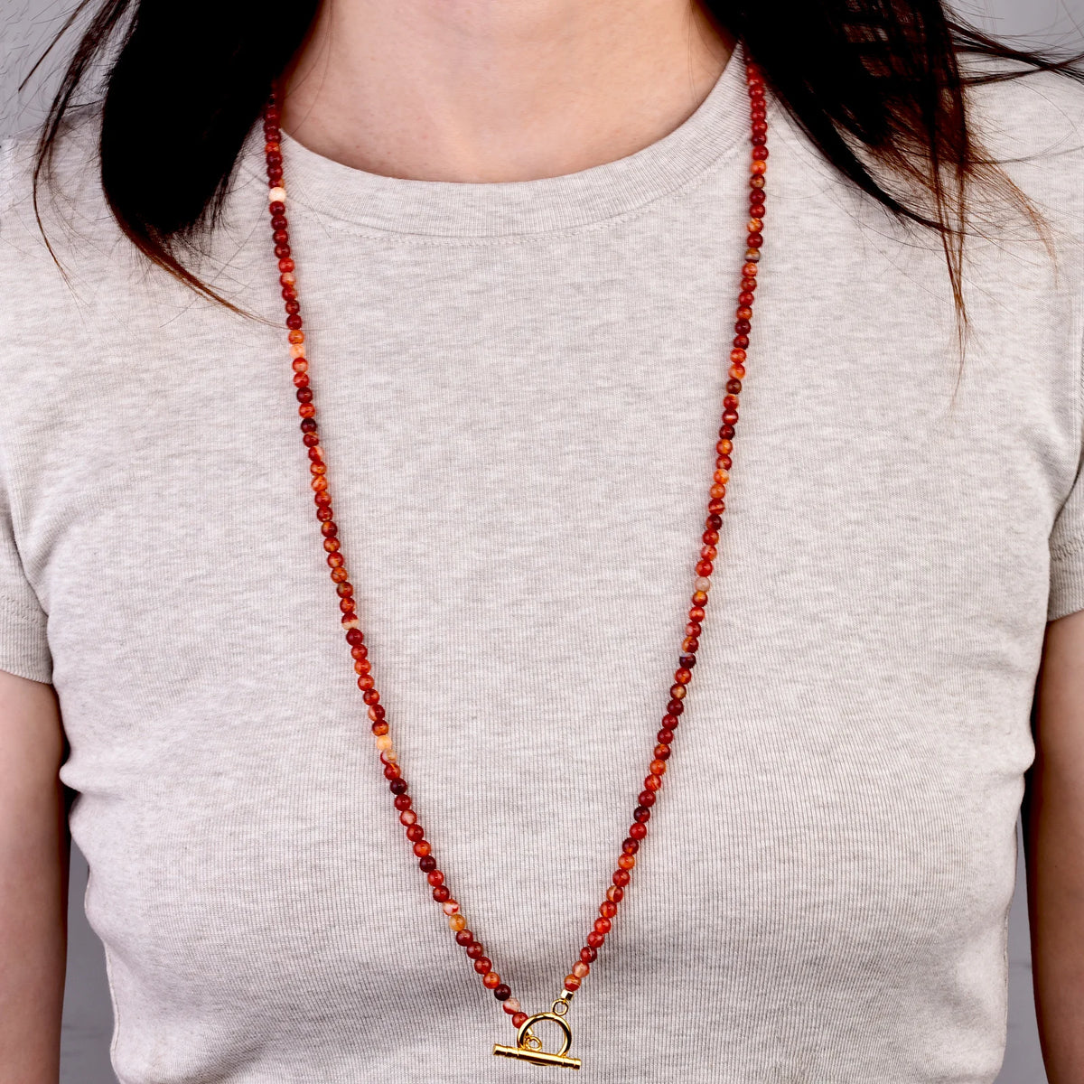 Long carnelian bead necklace worn, front view