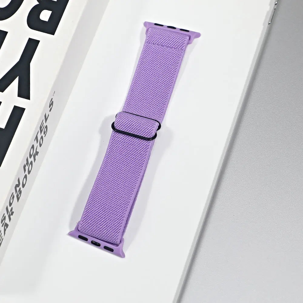 Purple nylon sport loop strap for Apple Watch, breathable and versatile for daily wear and workouts.