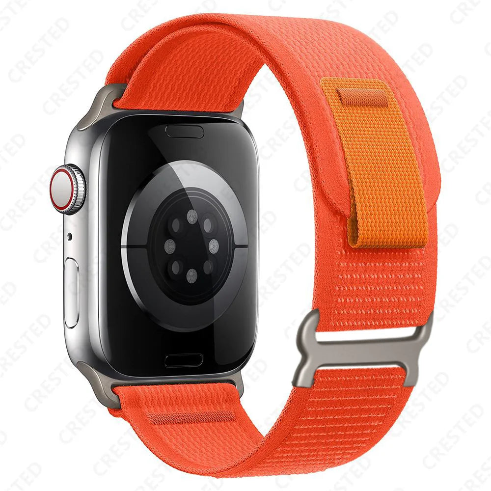 Apple Watch with orange Trail Loop nylon strap, designed for comfort, durability, and quick adjustment for wrist fit.