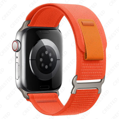 Apple Watch with orange Trail Loop nylon strap, designed for comfort, durability, and quick adjustment for wrist fit.