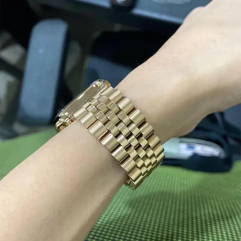 Gold five-row Apple Watch bracelet worn on wrist