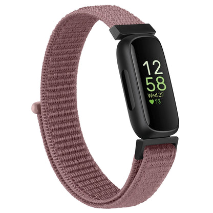 Fitbit Inspire 3 with adjustable nylon strap in mauve color, designed for comfort and everyday wear.