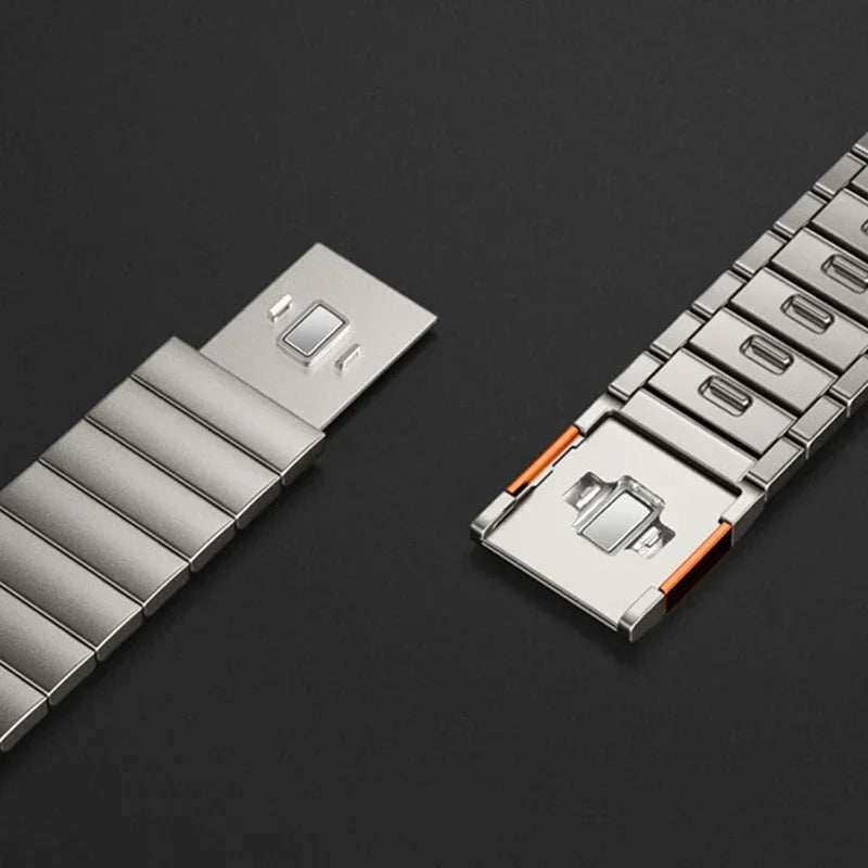 Close-up of Apple Watch stainless steel band with magnetic buckle strap, showcasing secure closure and polished finish.