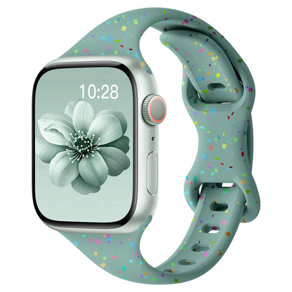 Apple Watch silicone band in soft blue with colorful speckles, showcasing its comfort and flexible design.