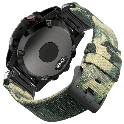 Garmin smartwatch with rugged nylon sport band in green camo pattern, highlighting secure G-hook closure and durable design.