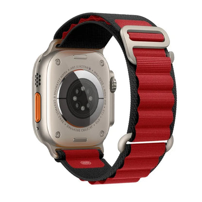 Apple Watch with rugged nylon Alpine Loop strap in red and black, designed for durability and comfort during outdoor activities.
