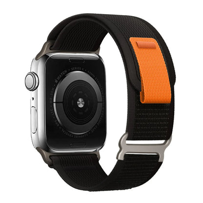 Apple Watch with Trail Loop Nylon Strap, featuring a stylish black and orange design for comfort and durability.
