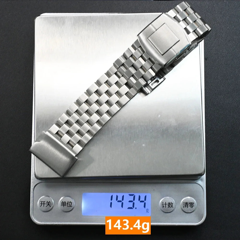 Garmin stainless steel replacement smartwatch strap weighing 143.4 grams on a digital scale.