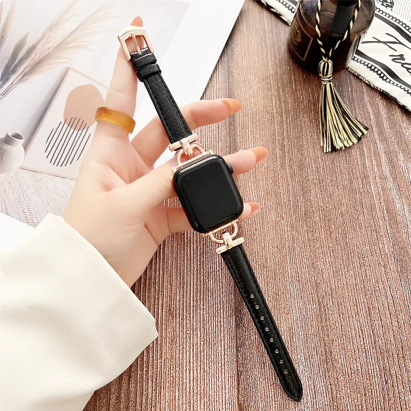 Apple Watch Genuine Leather Strap displayed on hand, showcasing classic black design and elegant buckle detail.
