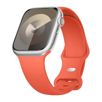 Apple Watch with a soft, flexible orange silicone strap, designed for comfort and waterproof for active lifestyles.