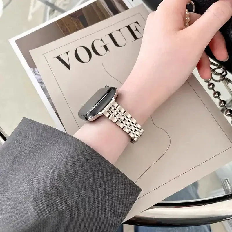 Slim stainless steel Apple Watch bracelet worn on wrist