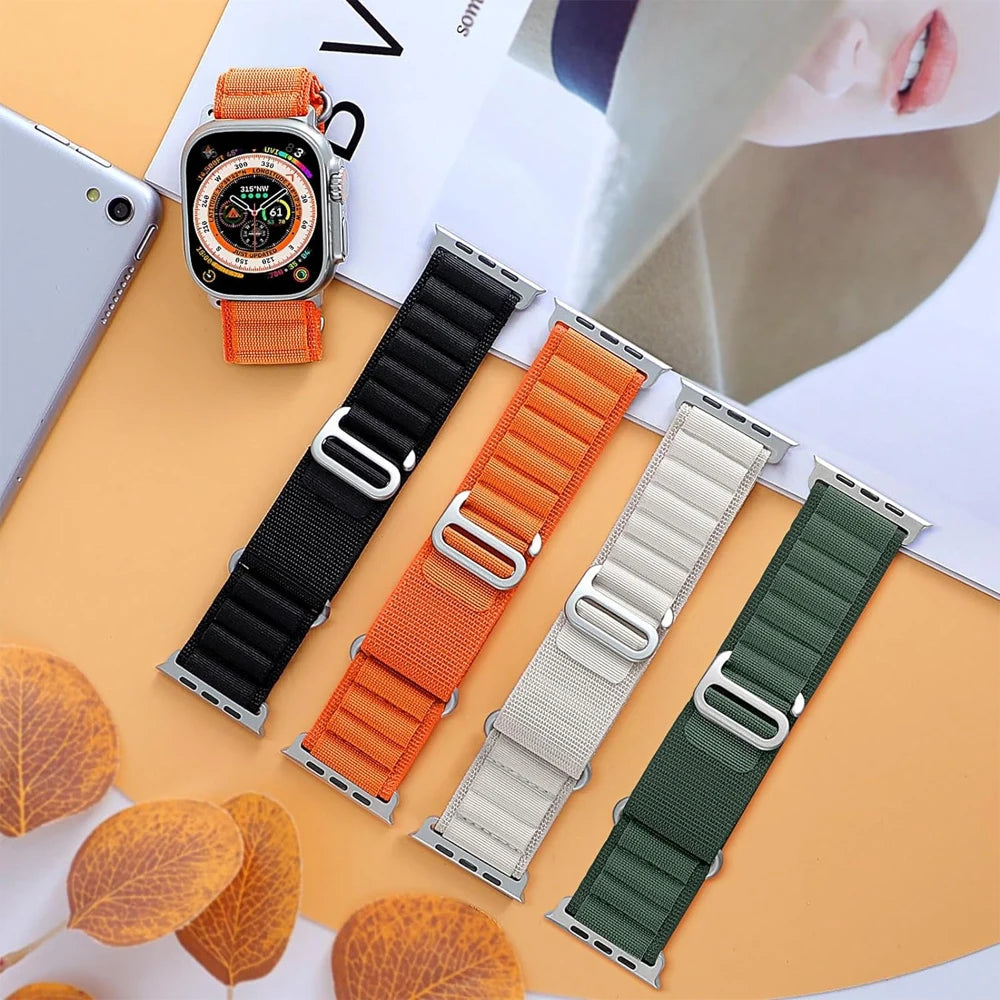 Apple Watch Nylon Strap collection with rugged alpine loop in black, orange, green, and beige, ideal for adventurers and style.