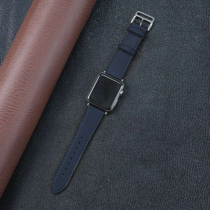 Apple Watch with navy fabric band on leather background, showcasing durability and stylish design.