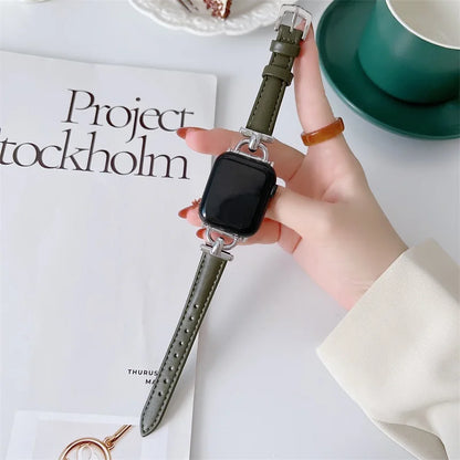 Apple Watch with genuine leather strap showcased on a table with a magazine and a green cup, highlighting its stylish design.