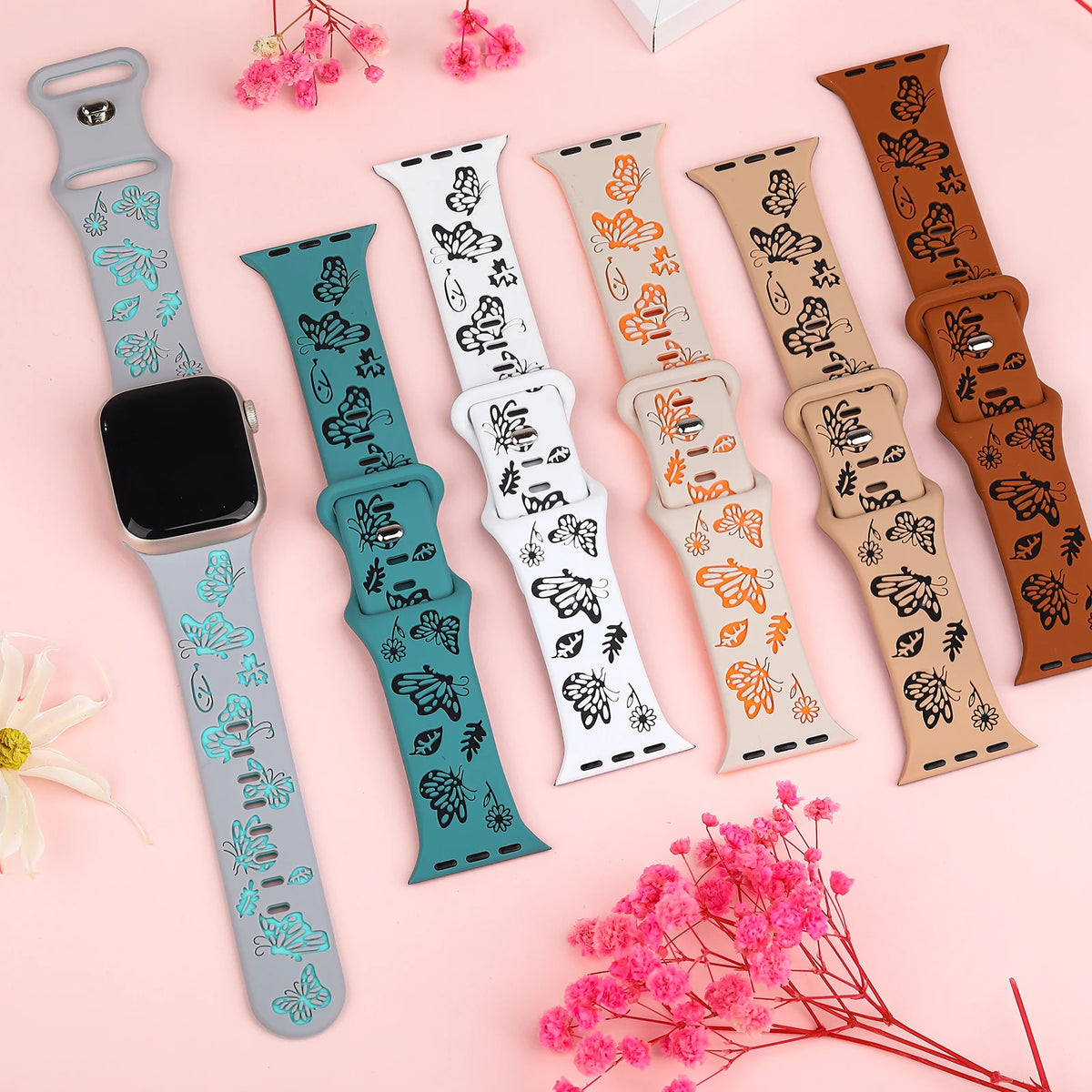 Several two-tone butterfly bands displayed side by side for Apple Watch