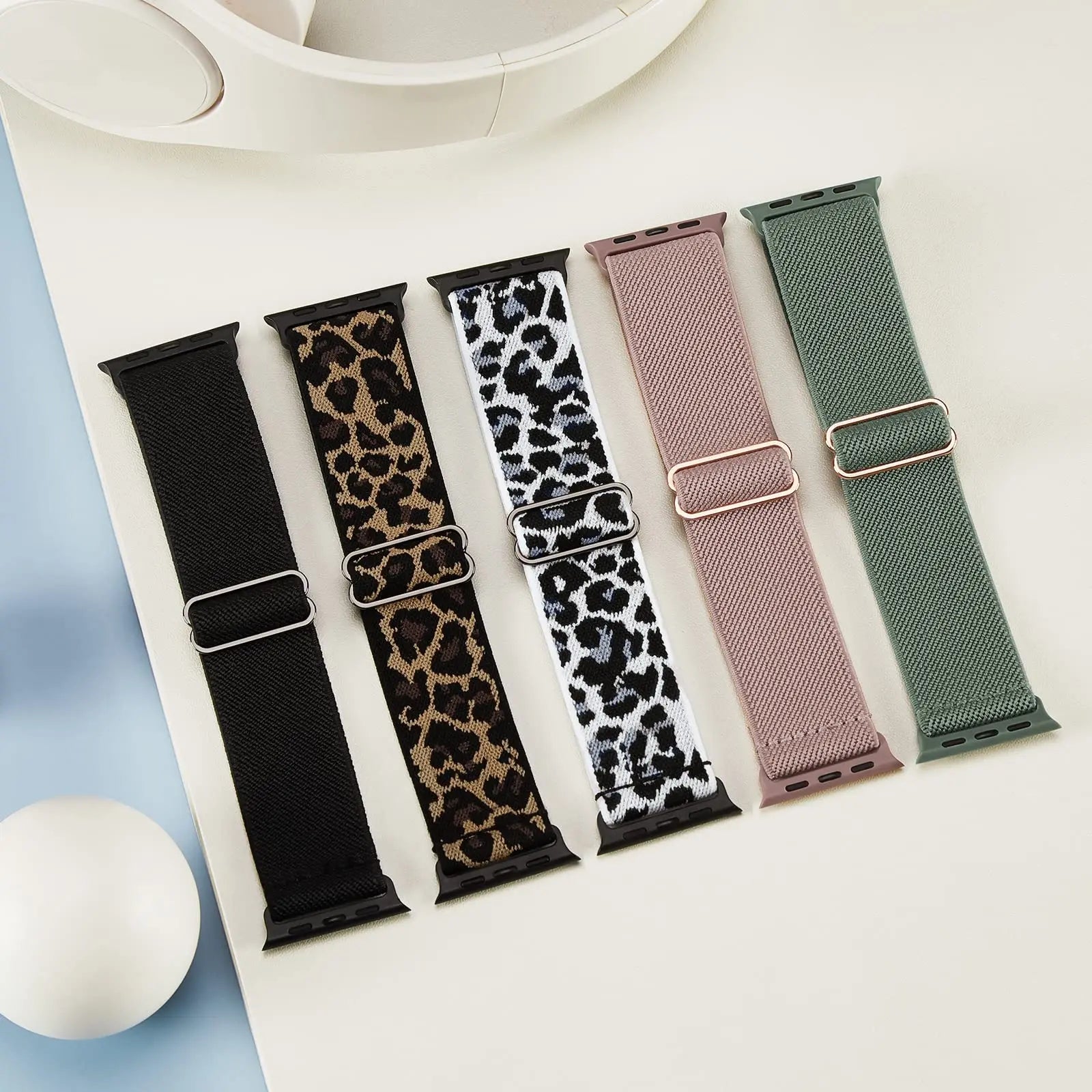 Collection of five Apple Watch nylon sport loop straps in trendy colors and patterns for stylish wear.