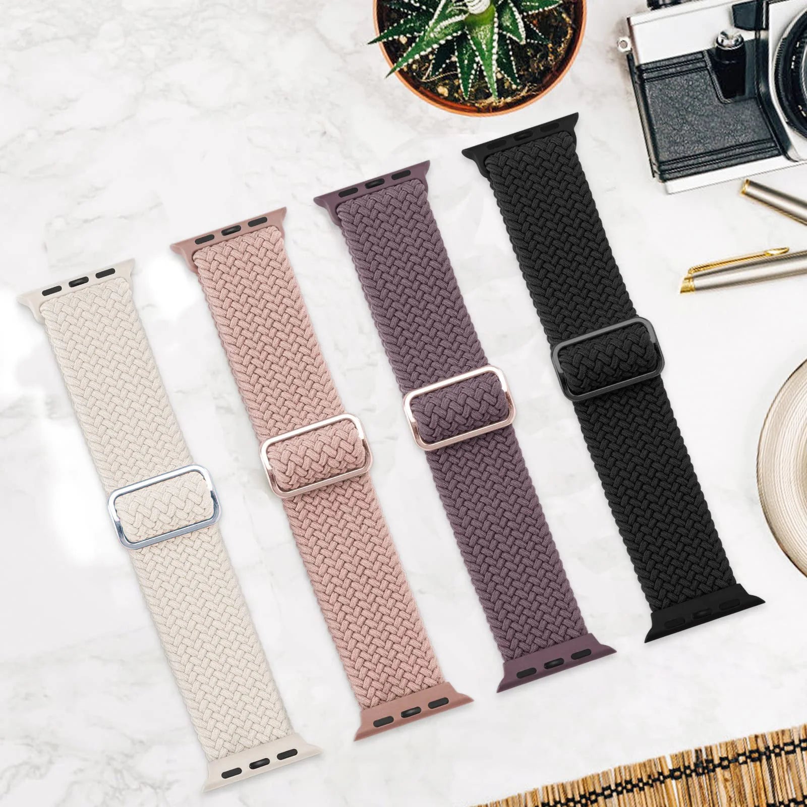 Apple Watch Braided Straps in four colors: cream, pink, purple, and black on a stylish background.