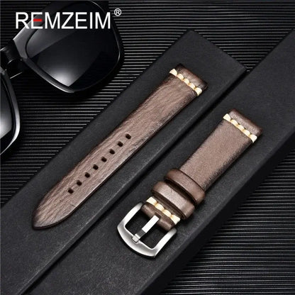 Stylish brown leather watch band with metal buckle, packaged alongside sunglasses against a sleek background.