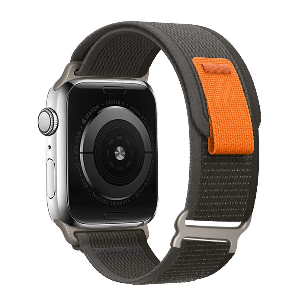 Apple Watch with Trail Loop nylon strap displaying durability and comfort, featuring gray and orange colors.