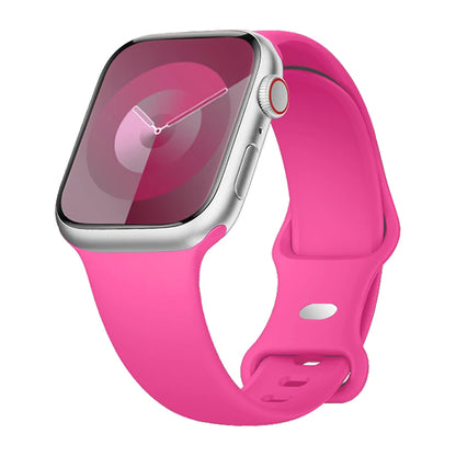Apple Watch with pink silicone strap, soft, flexible, and waterproof for comfort during workouts.