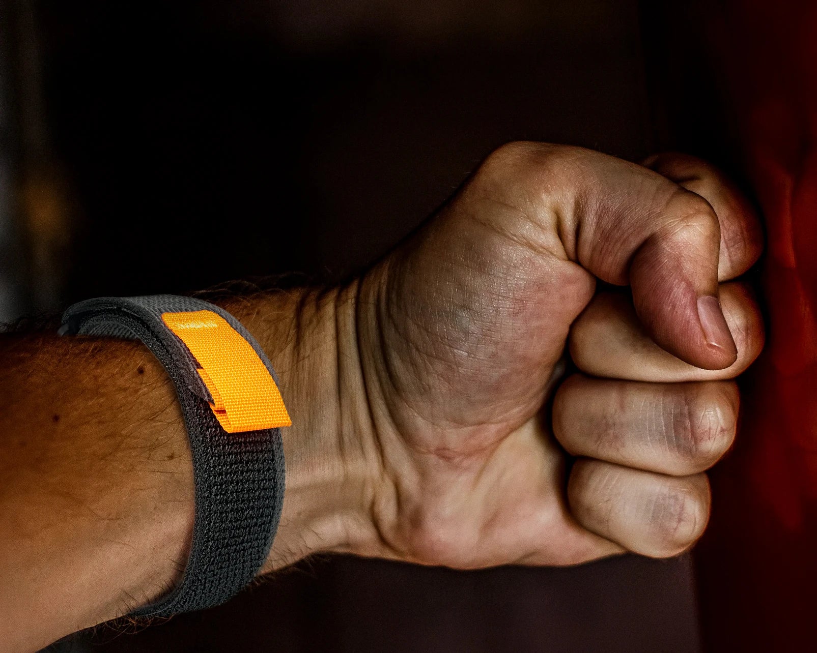 Close-up of a hand with a Garmin woven nylon sport band, showcasing durability and comfort for active lifestyles.