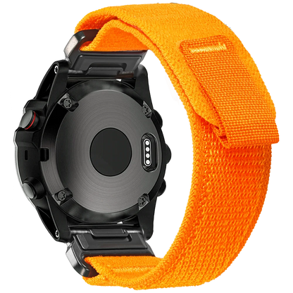 Garmin smartwatch with bright orange woven nylon replacement band for durability and comfort.