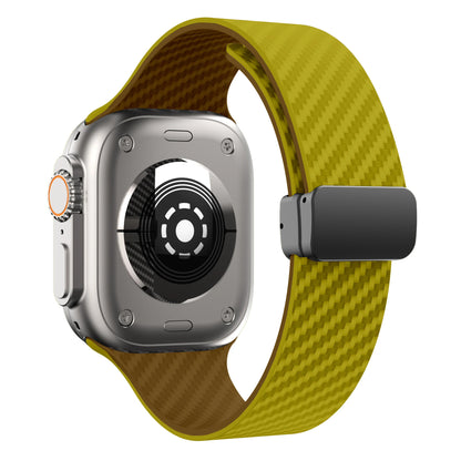 Apple Watch with a yellow silicone strap featuring a magnetic buckle for durability and comfort.