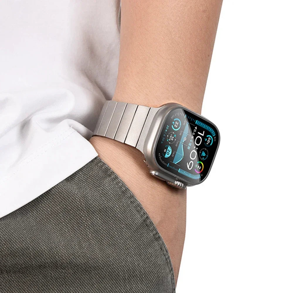 Apple Watch with stainless steel band and magnetic buckle, worn casually on wrist.
