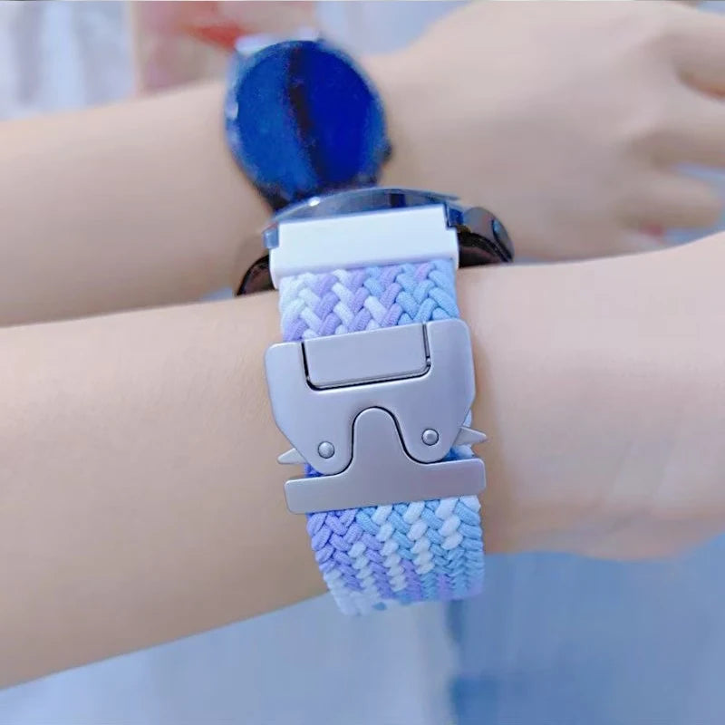 Close-up of Garmin smartwatch with colorful braided nylon strap, featuring a durable quickfit buckle.