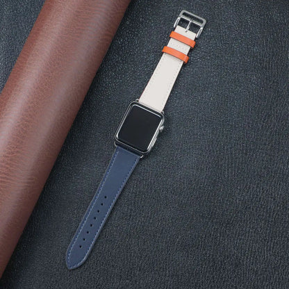 Apple Watch Fabric Band in stylish navy, cream, and orange, featuring a metal buckle clasp on a dark leather background.