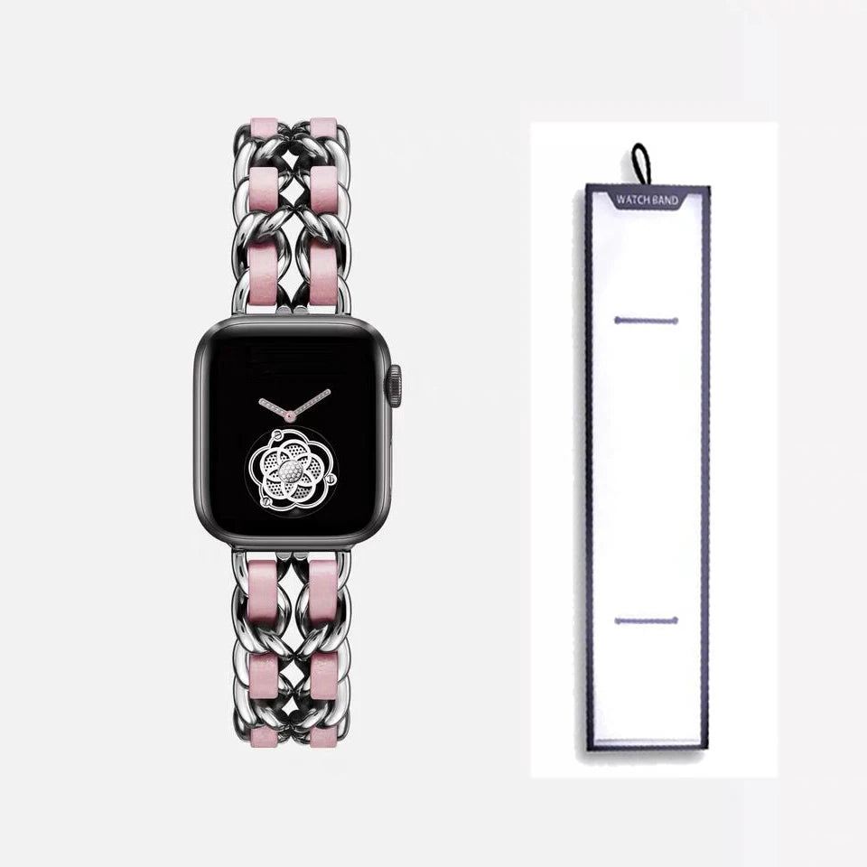 Silver chain bracelet with pink accents, shown beside packaging for Apple Watch