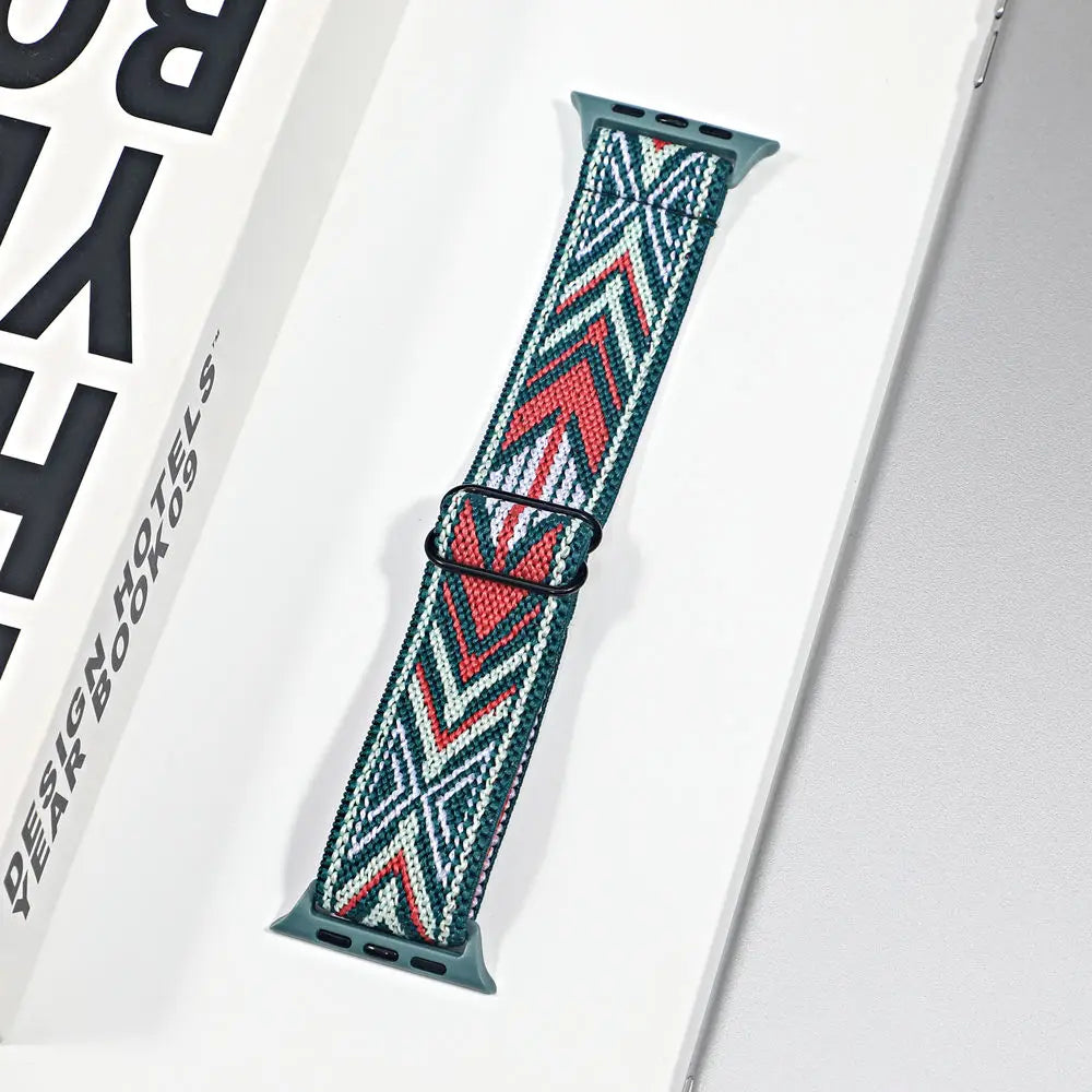Apple Watch nylon sport loop strap in blue, green, red geometric pattern, comfortable and breathable for all-day wear.