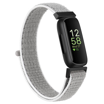 Fitbit Inspire 3 with a gray nylon strap on a white background, offering comfort and style for everyday wear.