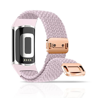 Fitbit Charge 5 6 braided band in light pink with magnetic buckle for smartwatch, combining style and comfort.