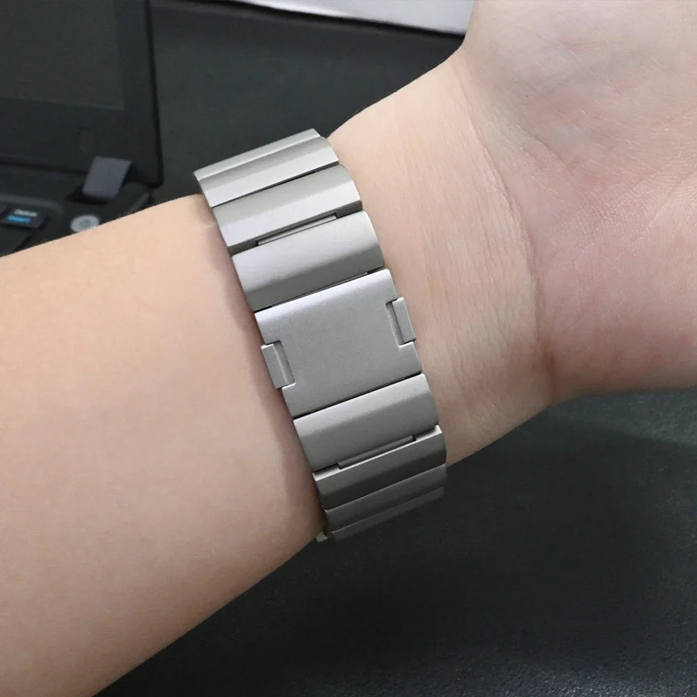 Close-up of a durable titanium bracelet on wrist, showcasing the sleek design of the Garmin replacement strap.