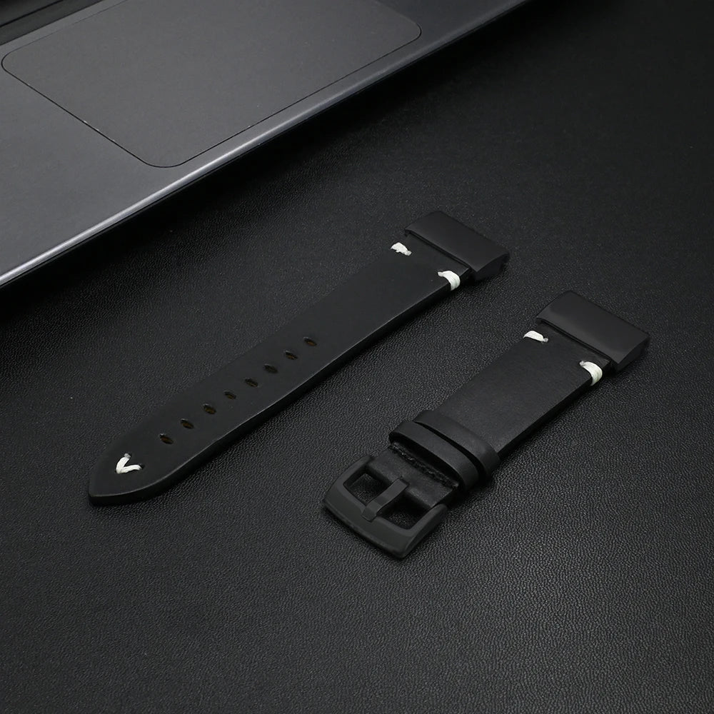 Black Garmin replacement strap displayed next to a laptop, perfect for style and comfort.