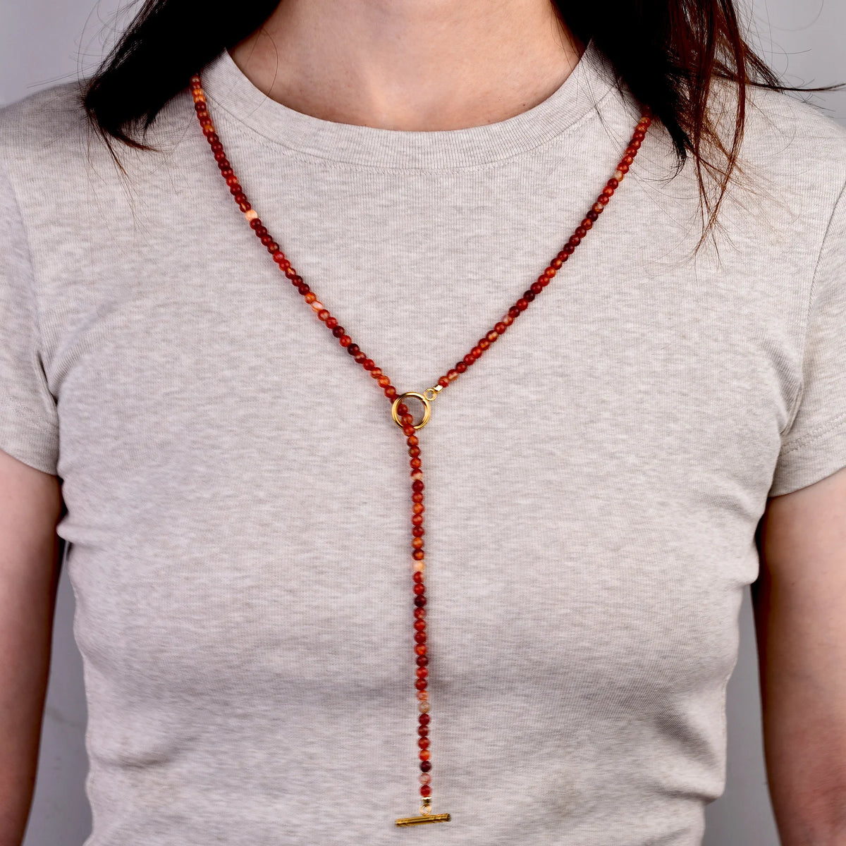 Long carnelian bead necklace worn long