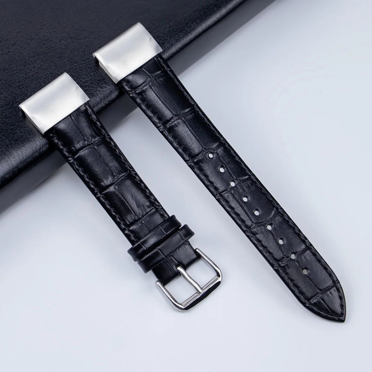 Garmin leather strap replacement band, stylish black design with silver buckle for smartwatch, adjustable fit.