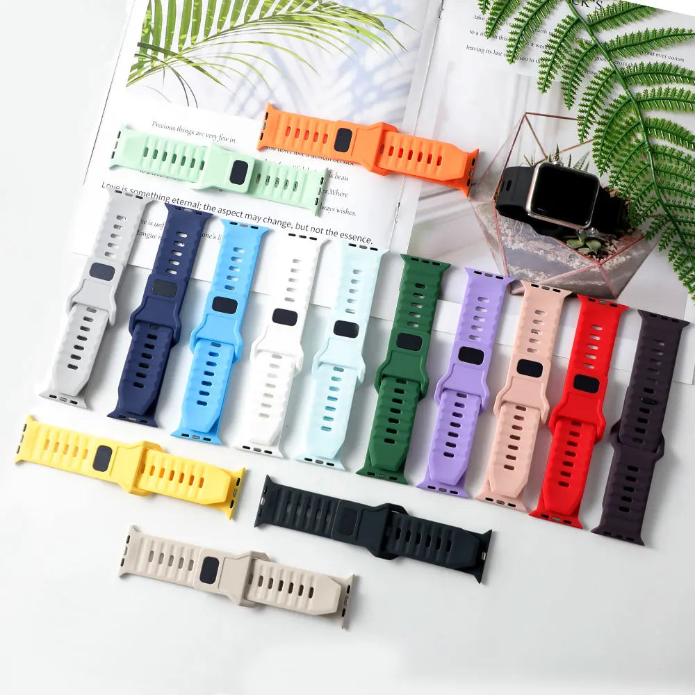 Silicone sport bands displayed in assorted colors for Apple Watch