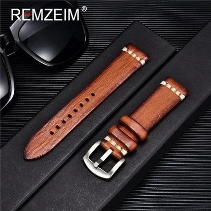 Stylish brown leather Suunto watch band displayed with sunglasses on a sleek black background.