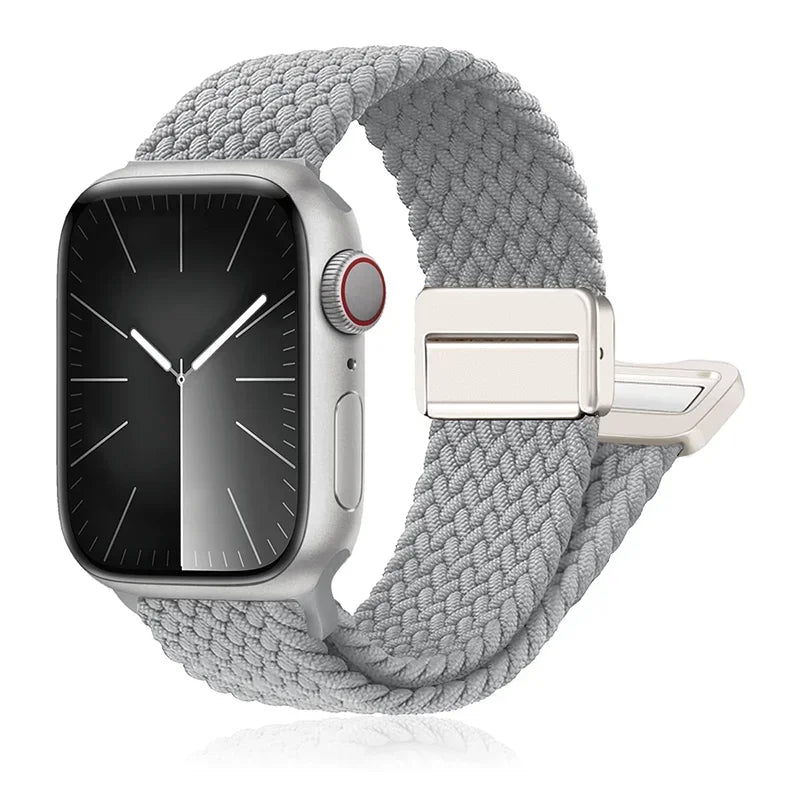 Apple Watch with a braided gray nylon band, featuring a stainless steel buckle for comfort and durability.