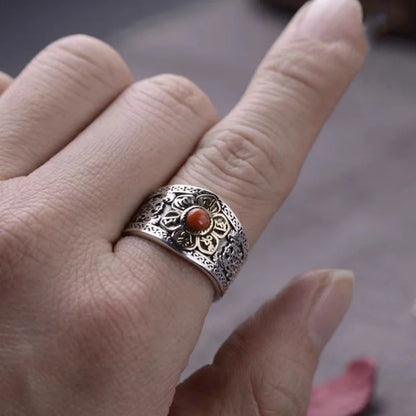 Carnelian flower ring worn on a finger